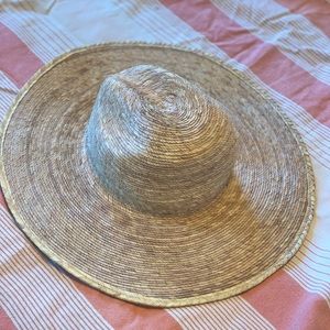 Large straw sun hat. Panama, cowboy, fedora style with large brim.